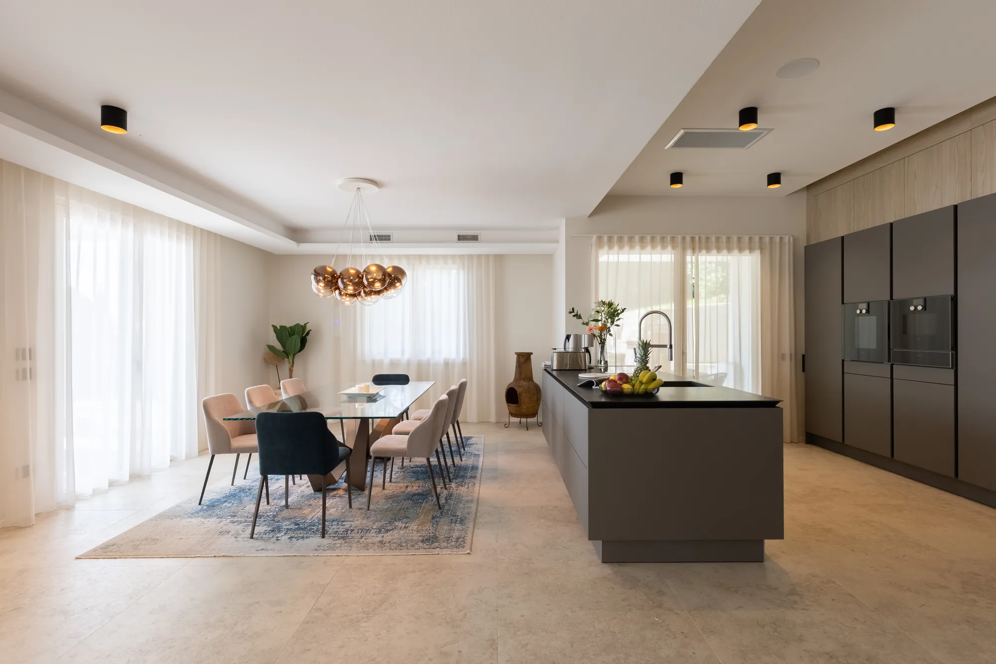 Modern kitchen with island and a dining table for eight