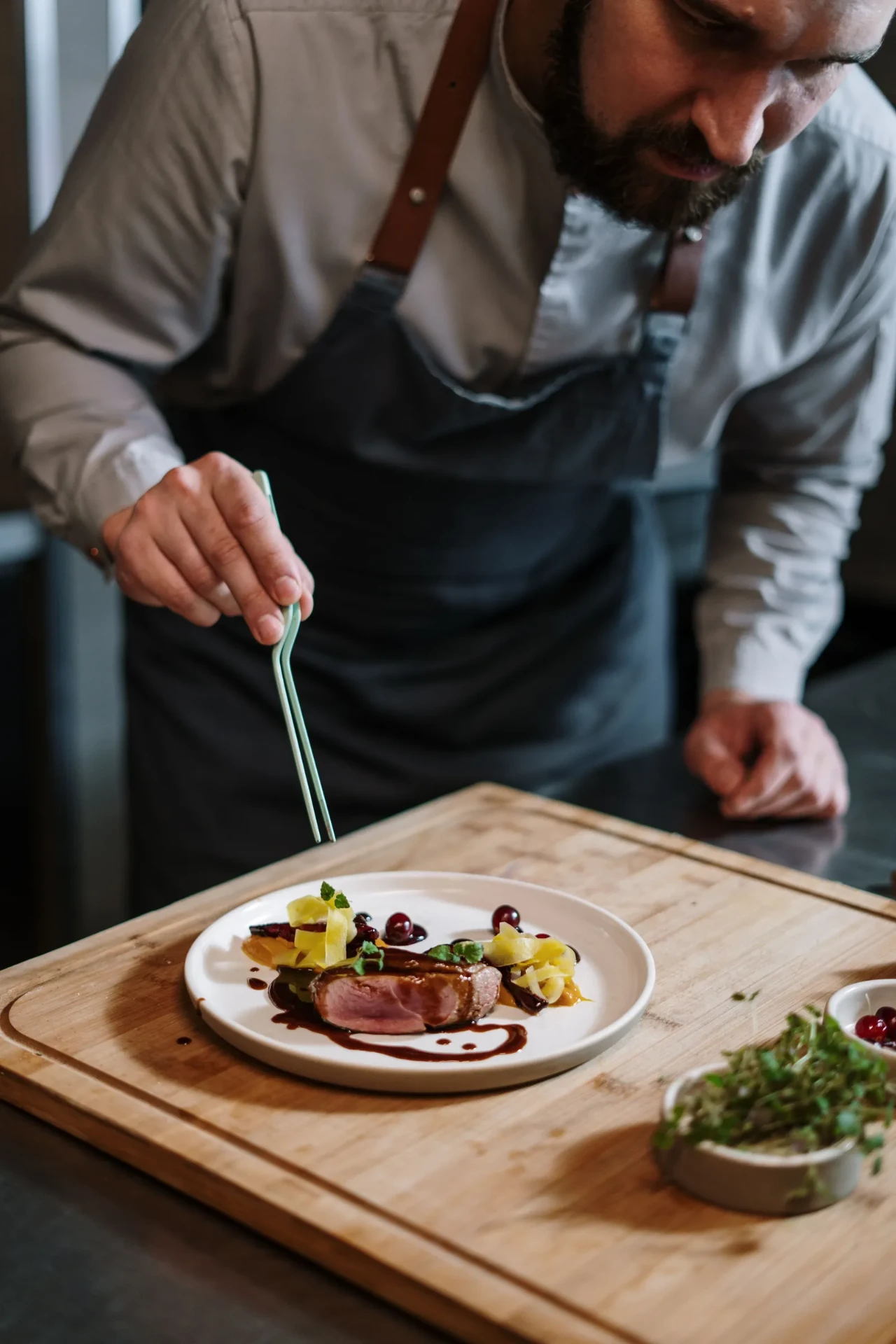 Private chef plating a dish for a dinner at the villa, Lake Garda