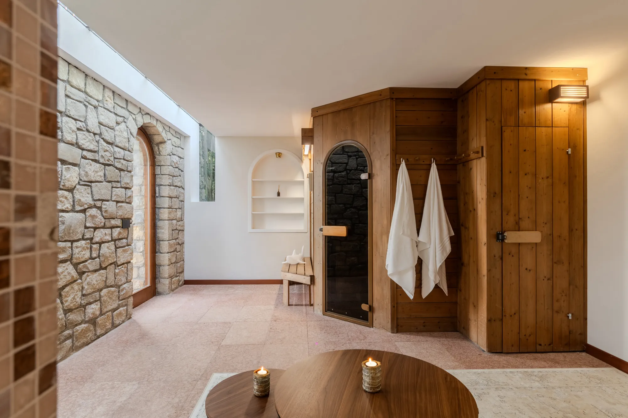 Private wellness room with Finnish sauna and exposed stone wall