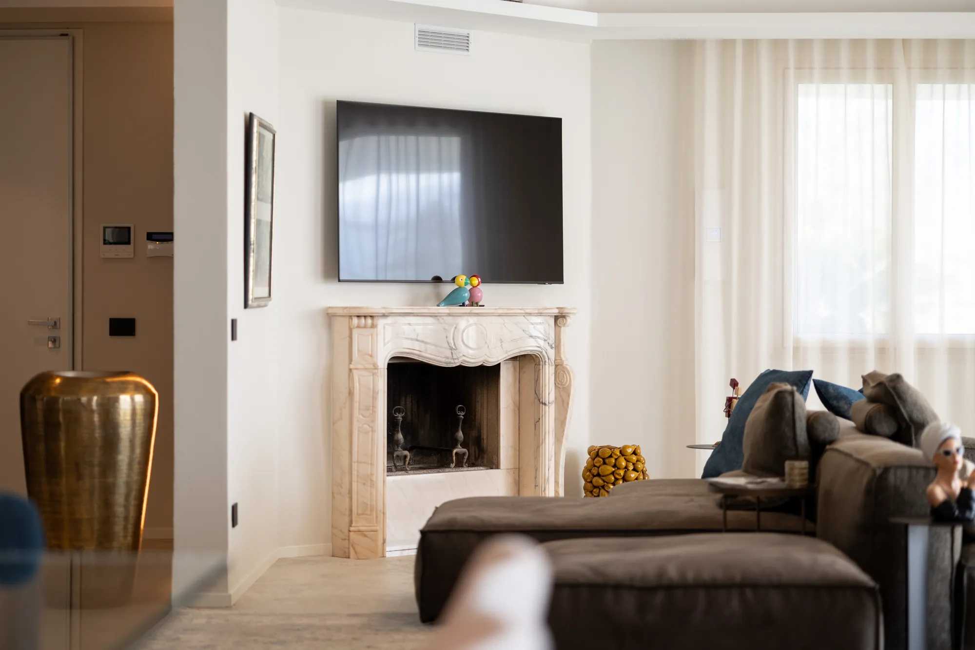 Living room corner with marble fireplace and sofa